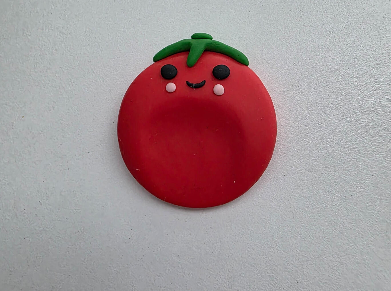 smiling red tomato worry stone