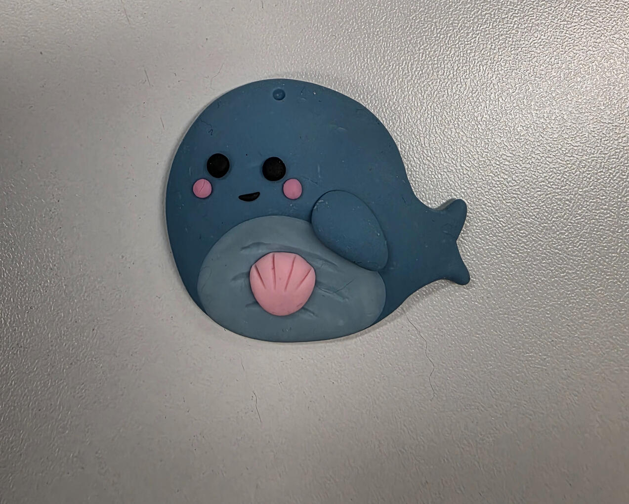 whale worry stone with pink clam shell